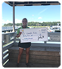 A man and a woman holding a huge check